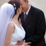 Bride and groom snuggle after wedding