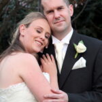 Content bride and groom by tree