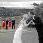 Bride and groom with best men and bridesmaids in background