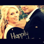 Couple pose with happily married sign