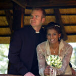 Bride and groom pose at wedding