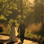 Bride and groom walk down road