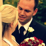 Groom smiles at bride