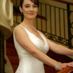 Bride stands on staircase at wedding