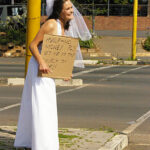 Bride having fun begging before wedding
