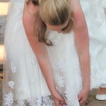 Bride fastens shoes