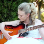 Bride plays guitar at wedding