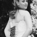 Bride posing with a guitar at a wedding