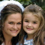 Bride posing daughter at wedding