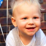 Toothy grin at first birthday party