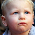 Unhappy child at birthday party