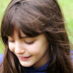 Portrait of a young girl playing