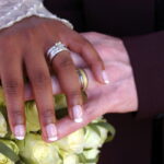 Photo of wedding rings on bouquet