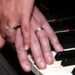 Wedding rings posed on piano