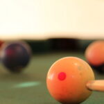 Pool player lines up a shot