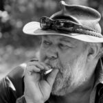 An ou oom smokes a cigarette at Val Hotel in Mpumulanga