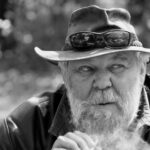 An ou oom smokes a cigarette at Val Hotel in Mpumulanga