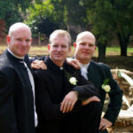 Groom poses with best men