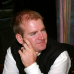 Proud groom looks on at wife